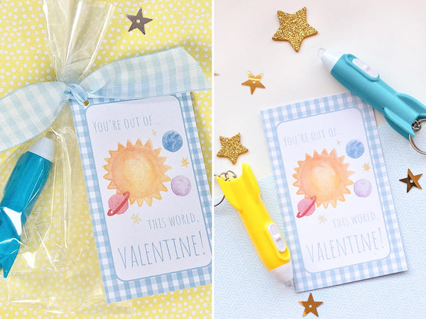 printable valentine's day cards with out of this world on it and a space scene tied to a gift bag with plastic rocket ship keychain