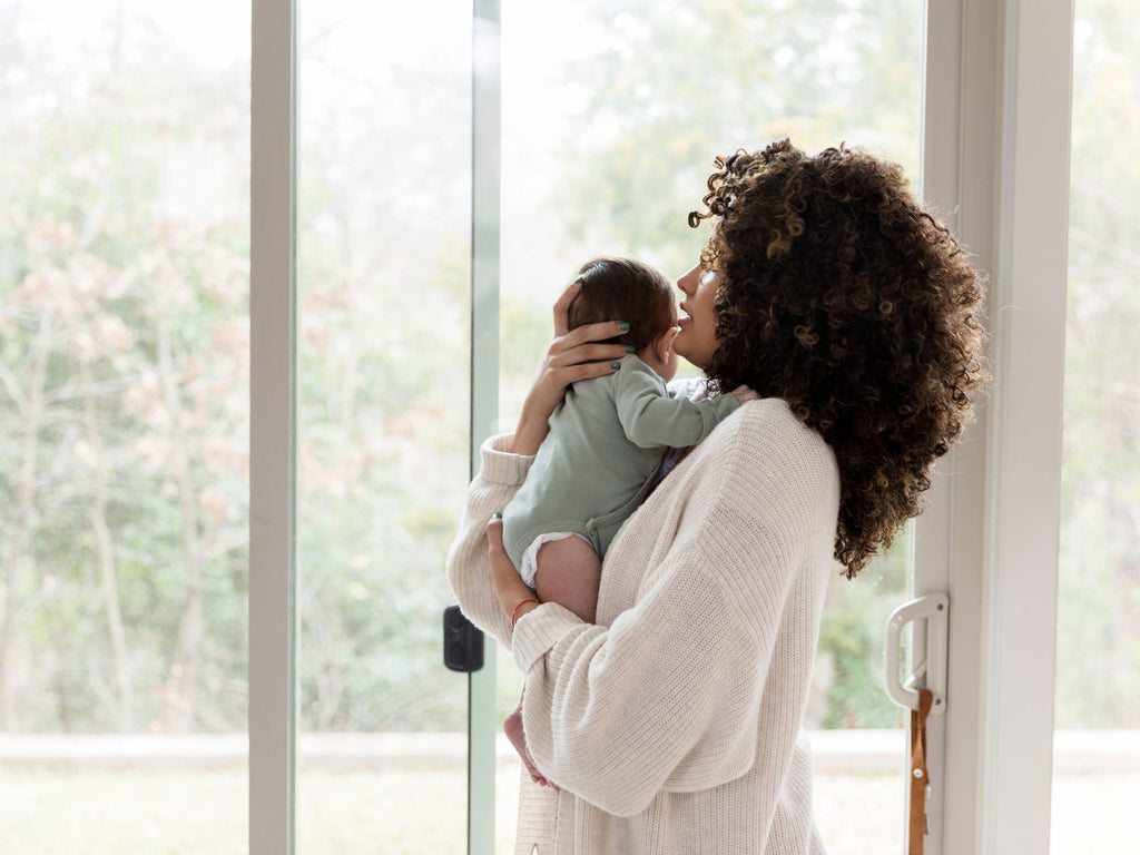 woman holding her newborn baby