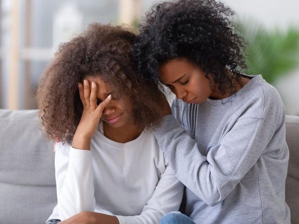 woman getting a hug from someone else