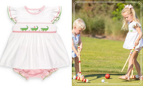 little boy and little girl wearing a smocked alligator set playing croquet