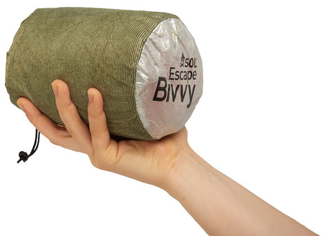 SOL Escape Bivvy held in the palm of a hand to highlight compact size