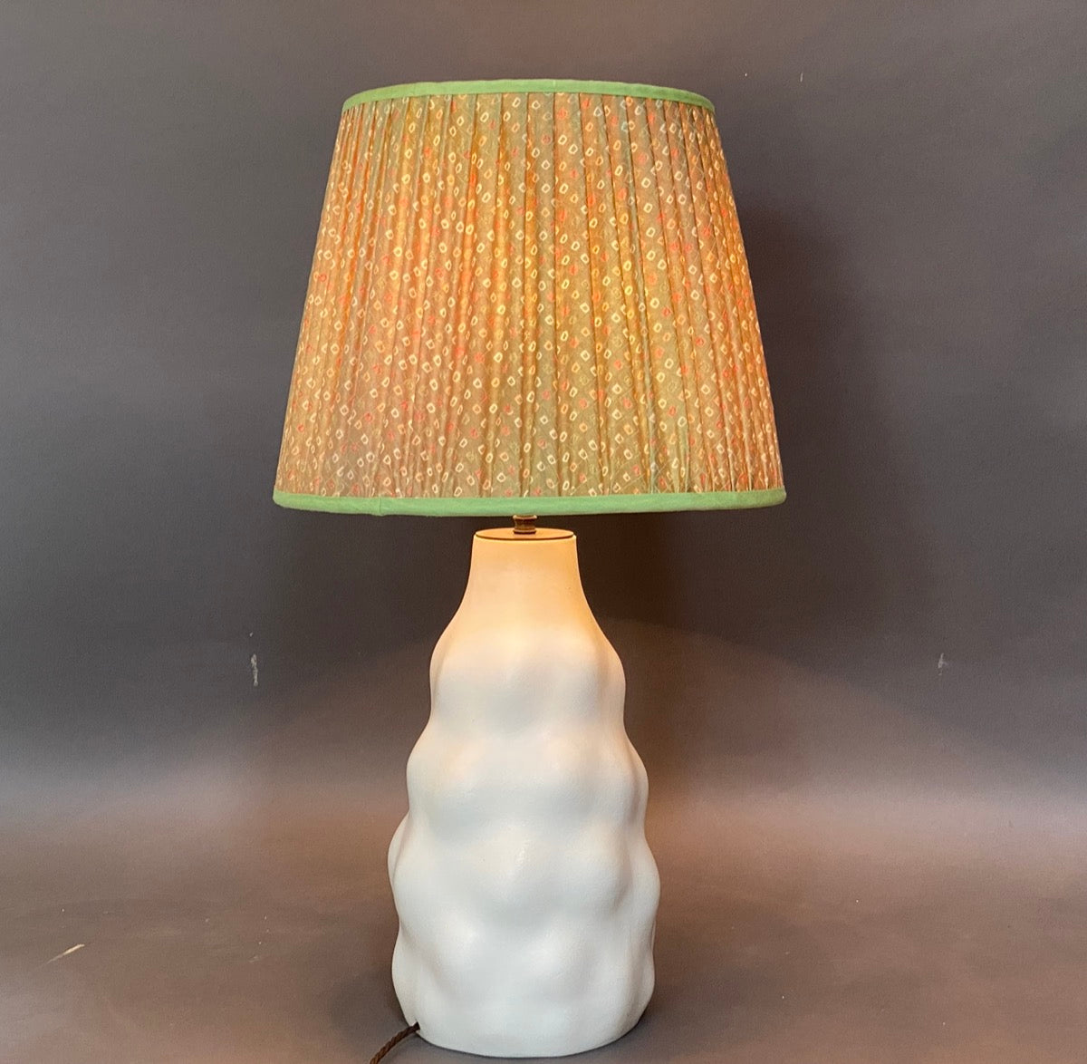 Green shibori lampshade on lamp