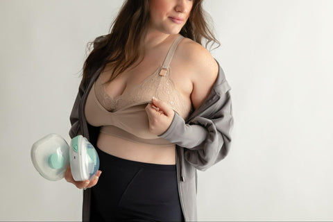 Woman using a nursing and pumping bra.