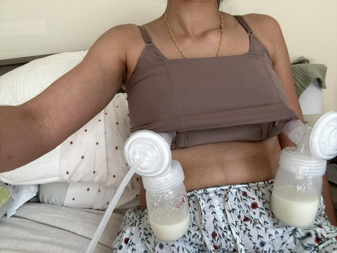 Woman using a breast pump while wearing the Davin and Adley Amelia cami.