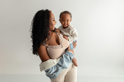 woman holding a young child while modeling a Davin & Adley Nursing bra