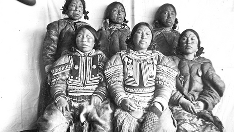 Indigenous People seated in tribal dress