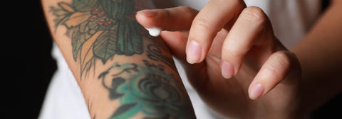 applying tattoo aftercare cream to tattoo