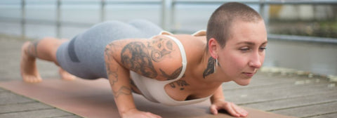 tattooed woman doing yoga