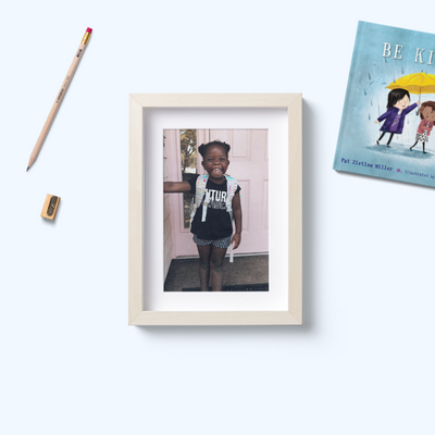 A photo of a young girl weating a backpack representing education charities