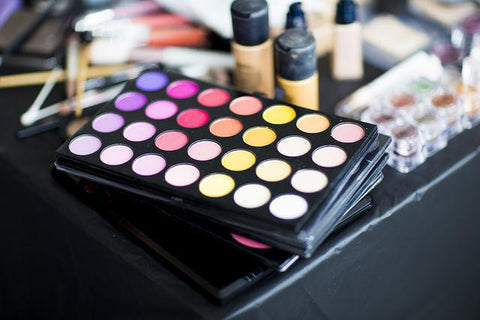 Various Cosmetics on a Black Surface