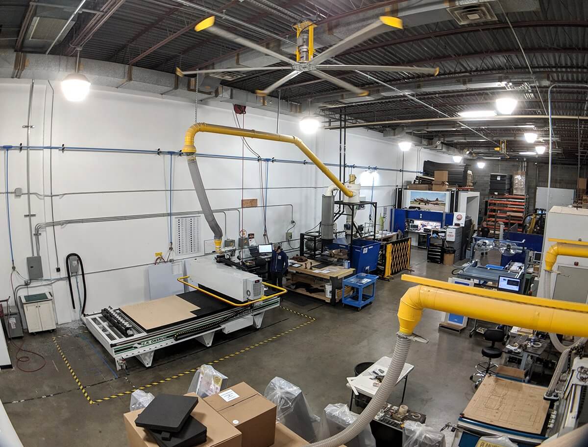 A photo of our warehouse, featuring CNC machines for cutting materials.