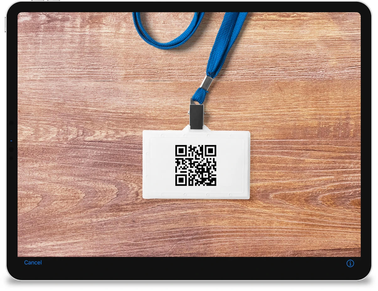 An iPad showing the native camera interface which is scanning a QR code from an ID badge.
