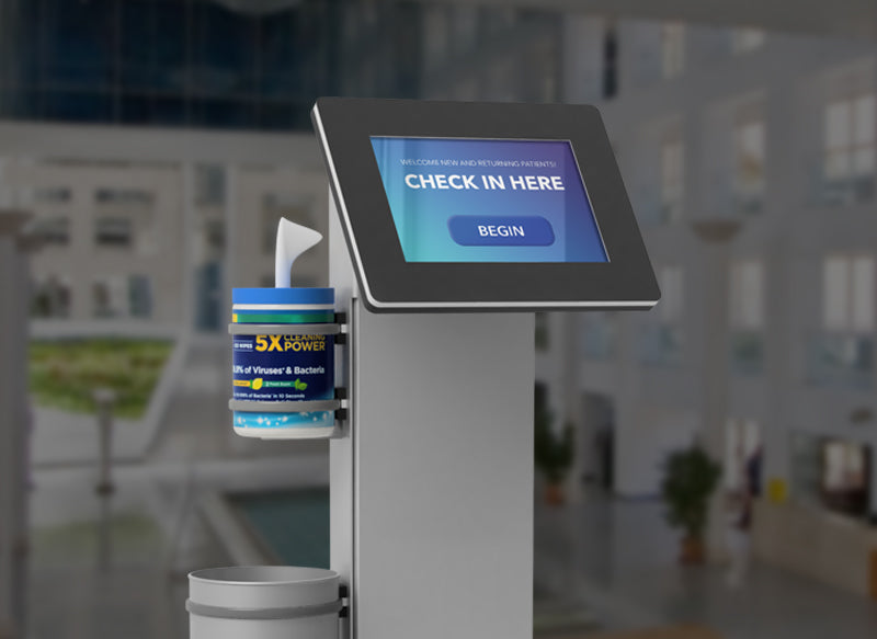 A free standing kiosk with a sanitation wipe holder and trash bin.