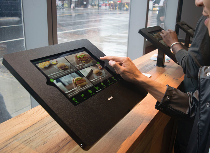 The Shake Shack kiosk, which includes a card reader and home button access.
