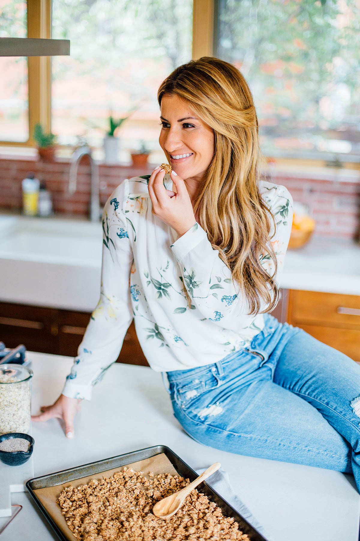 Elizabeth in kitchen eating granola