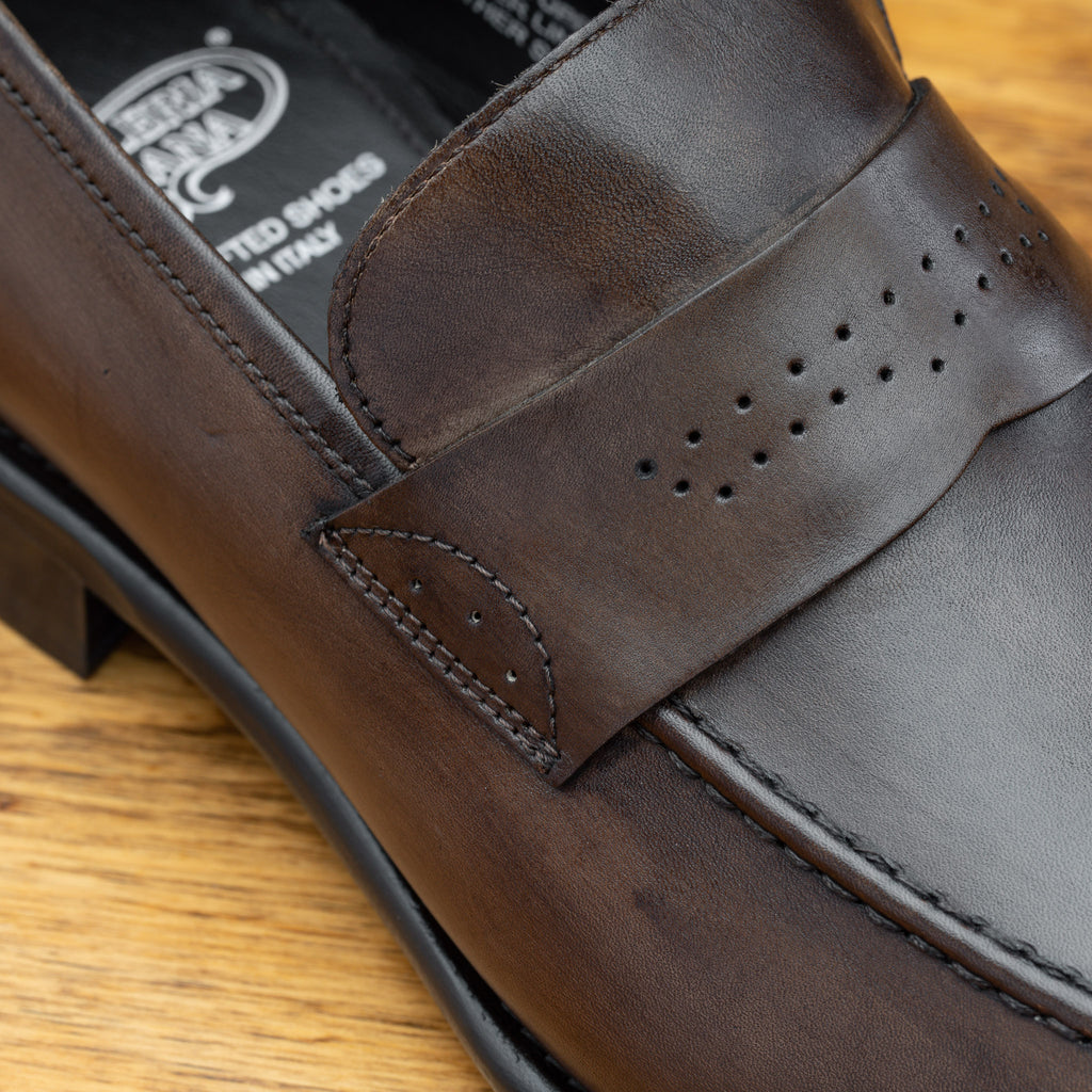 Up close photo of the penny strap with perforated details on Q540 Calzoleria Toscana Moor Wholecut Slip-On