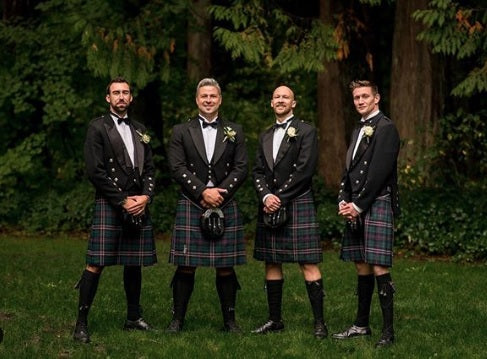 The groom and groomsmen wear a tux with the Scottish kilt 