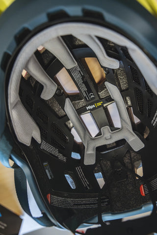 Close-up of a Mips liner inside a bike helmet, showing yellow low friction layer