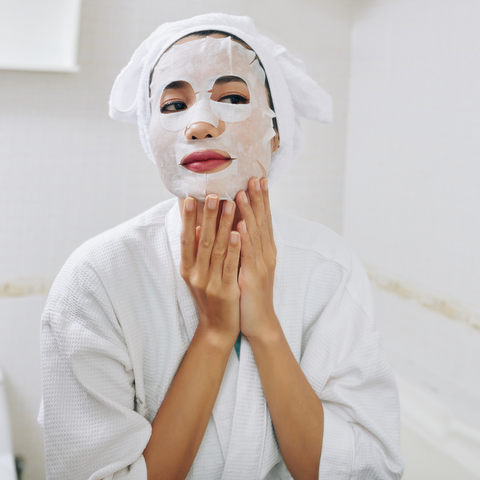 Woman with sheet mask on face 