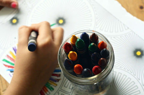 Child drawing with crayons