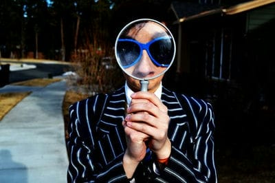 person looking throw a magnifying glass