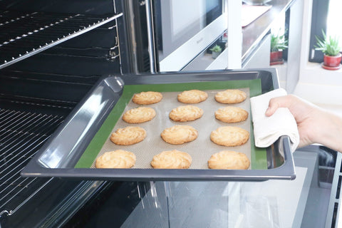 reusable silicone baking mat being used in the oven to bake cookies