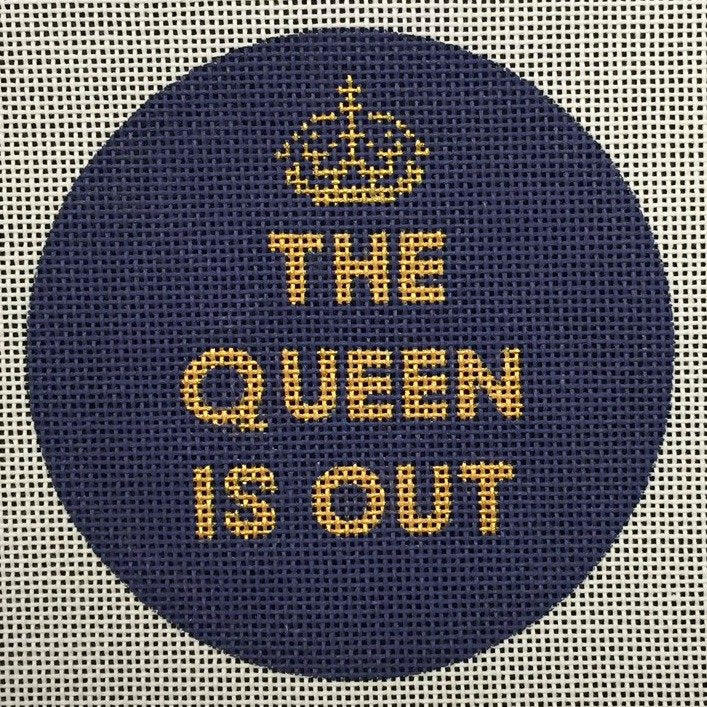 A cute needlepoint ornament with the saying The Queen Is Out. The