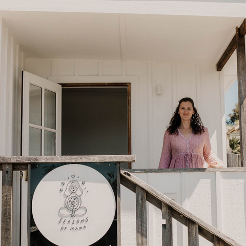 midwife and birth educator standing in front of her studio ready to teach birth classes.