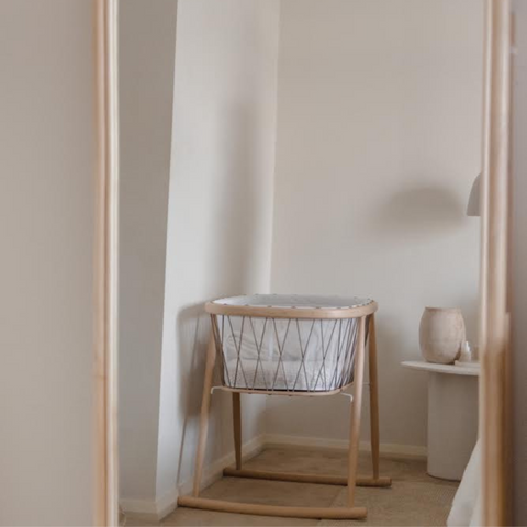 kumi bassinet from charlie crane paris sitting in bedroom waiting for a newborn baby to sleep in it.