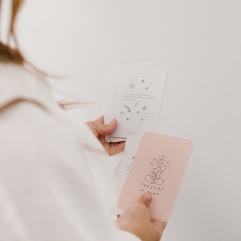 expecting mother reading calm birth affirmation cards preparing for birth.