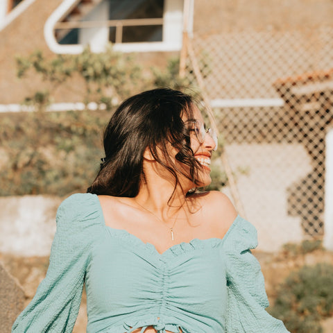 A dark-haired Latina woman enjoying the sun.