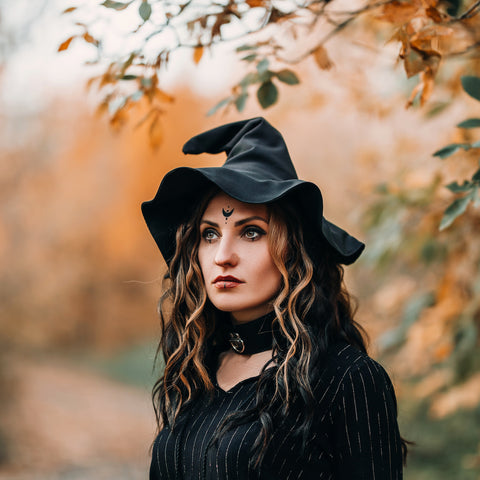 A young woman dressed up as a witch for Halloween.