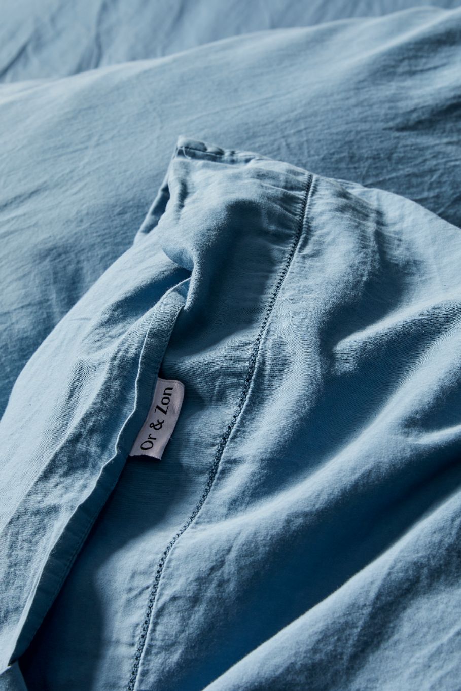 Aegean blue sateen bed sheets close-up