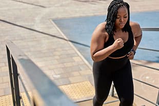 Frau nimmt beim Joggen die Treppen