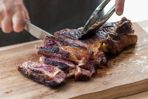 steak being sliced on a chopping board