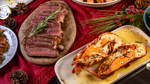 steak and lobster on a dining table