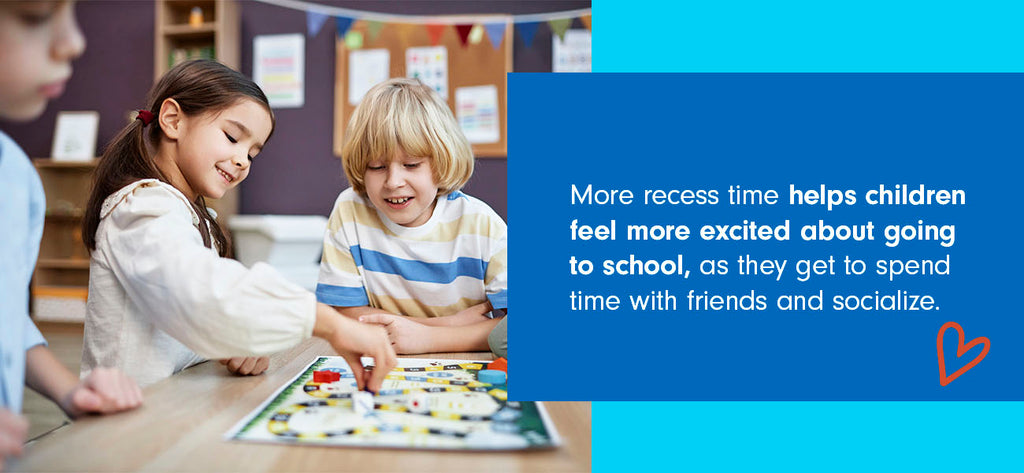 A young boy and girl play a board game in a classroom.