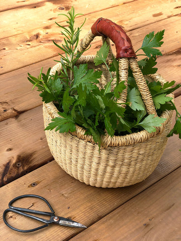 Panier artisanal bolga rempli de fines herbes