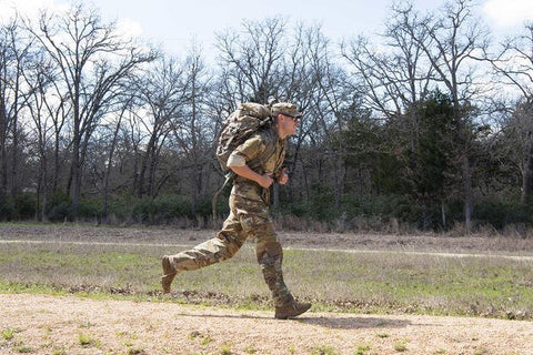 Soldier running with a ruck