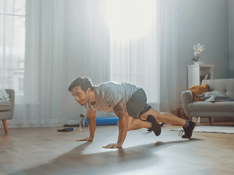 man doing mountain climbers in hotel