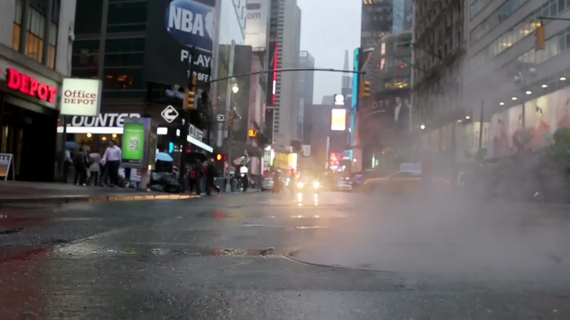 steaming manhole low view on midtown street in Manhattan on rainy day in 1080 HD