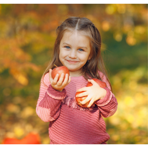 Small child with some apples - image from Canva