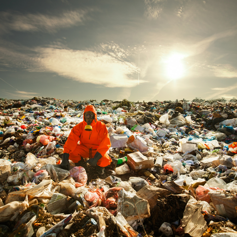 A person in the middle of a landfill - Canva image