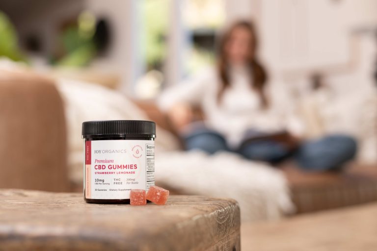 CBD Gummies in front of woman sitting on couch