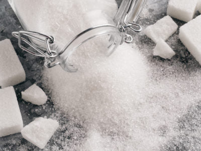 white sugar spilling out of jar