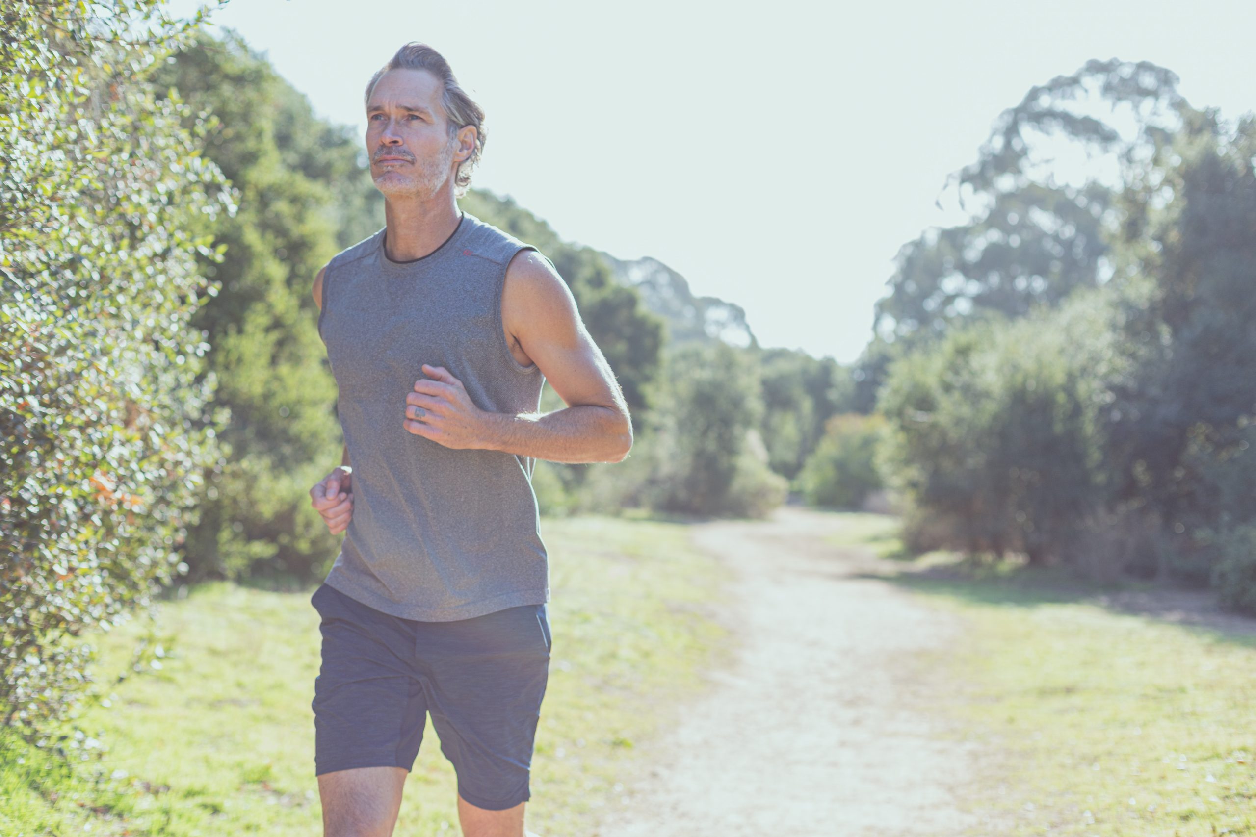 man running on path in the woods