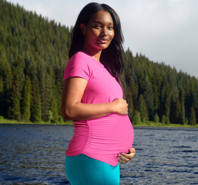 pink maternity top paired with blue maternity blue midi high waisted legging