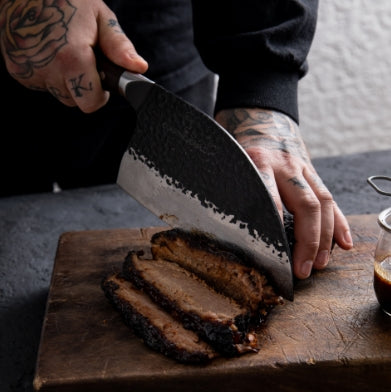 Man cutting beef brisket