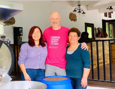 Jason, Nohelia, and Lillian roasting coffee at the San Lazaro Coffee farm in Honduras