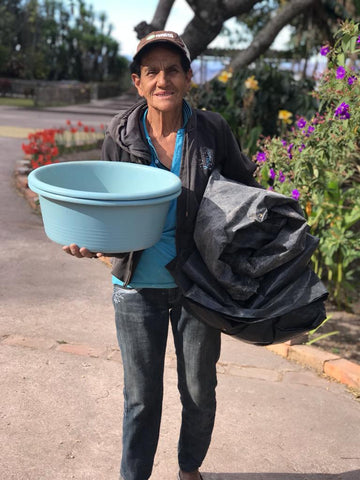 female coffee farmer with bucket to sort beans
